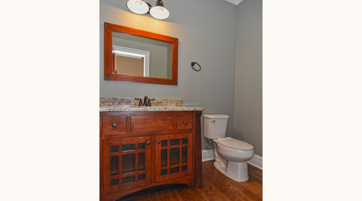 ICH Builders Mt. Sterling residence custom build bathroom featuring milled wood custom-made vanity and marbled countertop